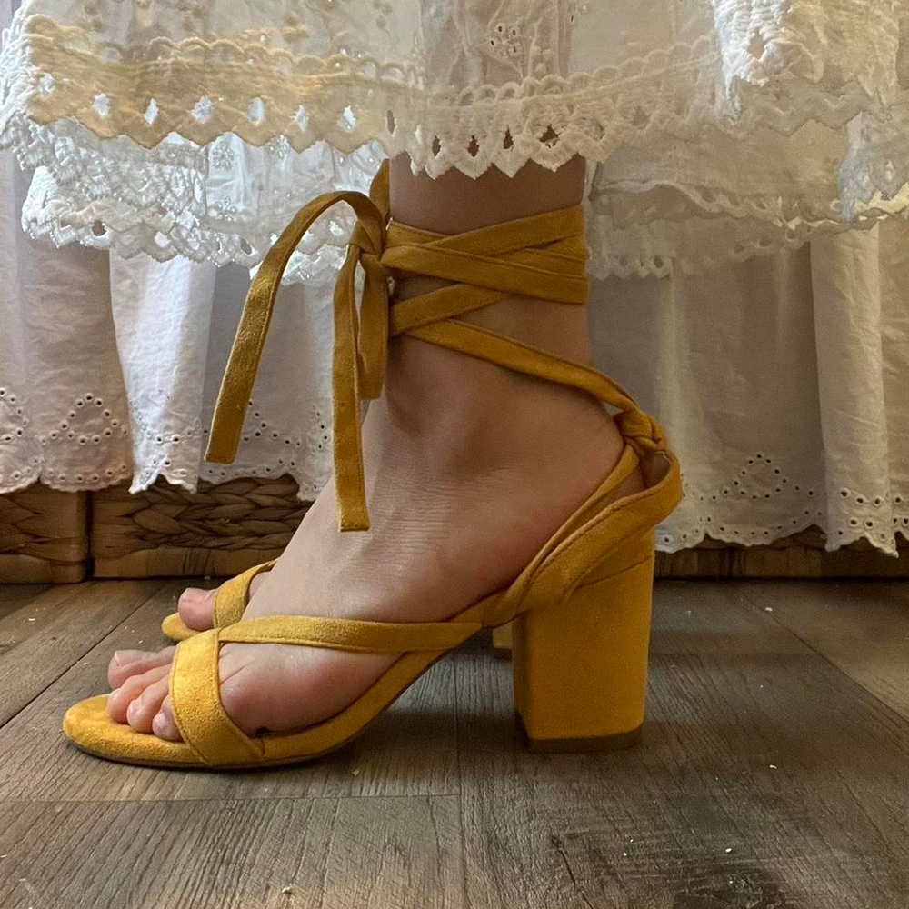 Yellow suede heels with a strappy design